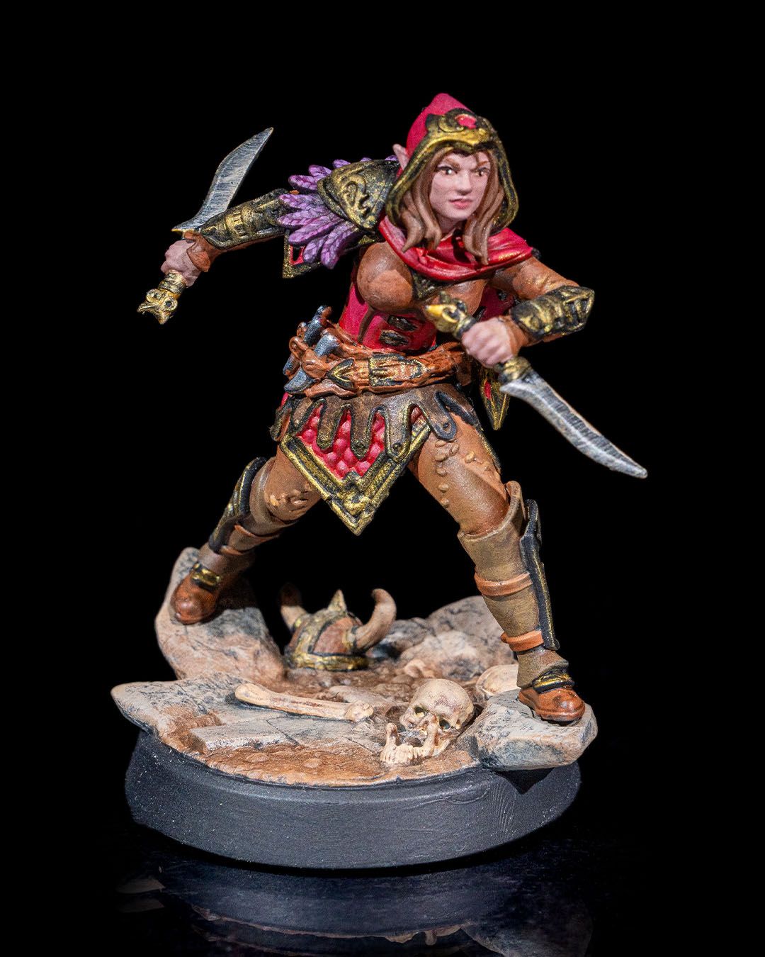 Painted Female Elf Rogue miniature with hood and dual blades, featuring detailed armor and elven aesthetics for fantasy tabletop RPGs. | Helios Tabletop
