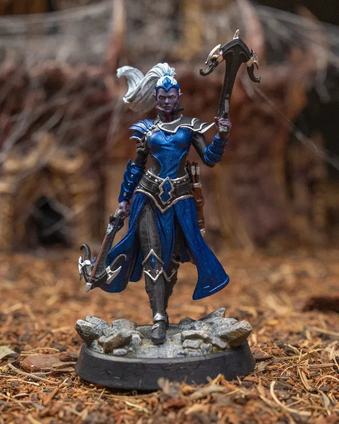Fully painted version of the Elf Ranger miniature with vibrant armor tones, lifelike skin tone, and detailed crossbow finishes over a rocky terrain base
