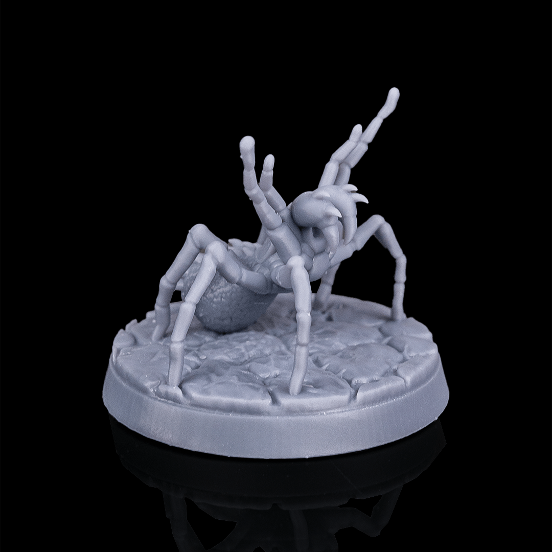 Spider-like creature figurine on a round base against a black background
