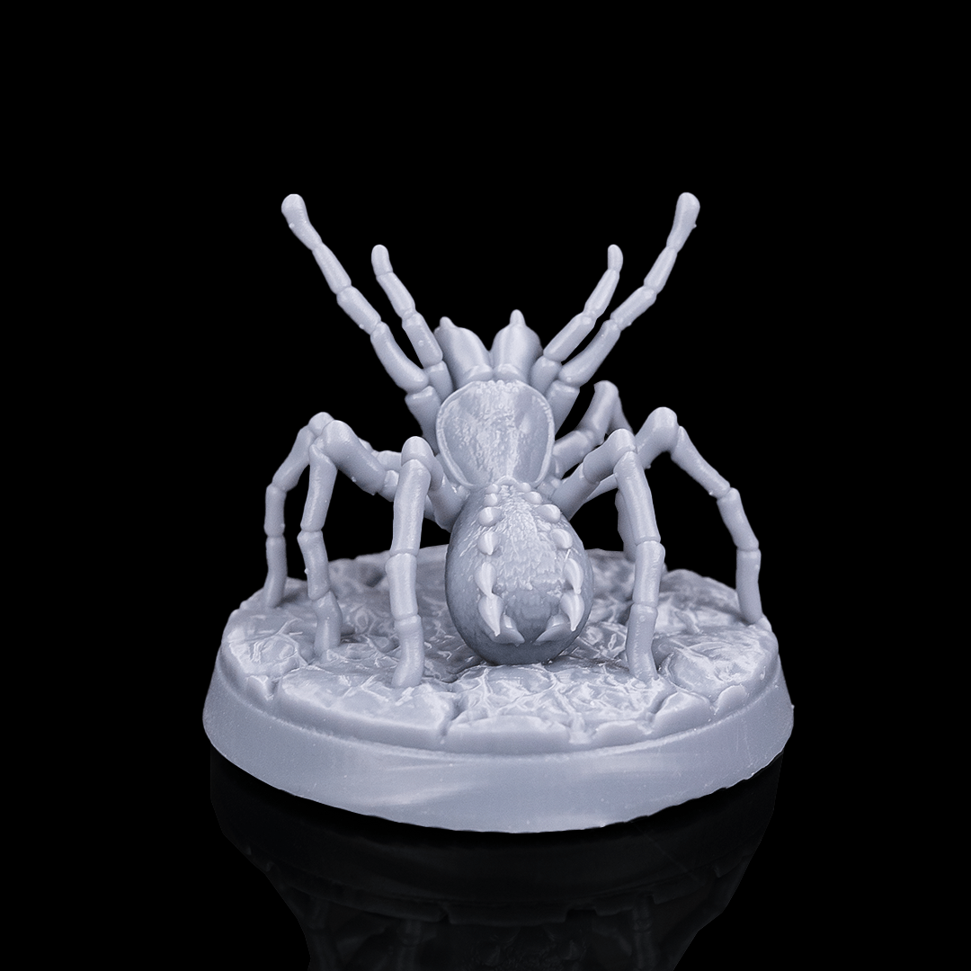 White spider-like creature figurine on a black background