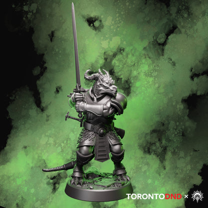 Front view of a Dragonborn Fighter miniature gripping a two-handed sword in a defensive combat stance