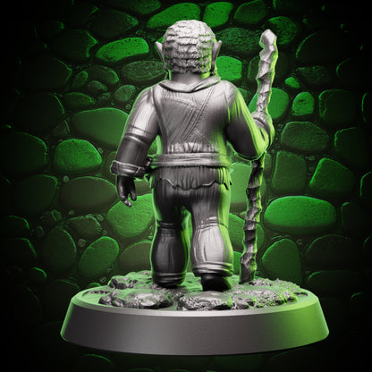 Back view of gnome druid showing tunic drape, belt wrap, and staff held at the side