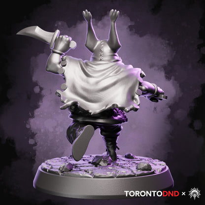 Rear view of a high-quality resin Halfling Rogue miniature showing flowing cloak, gear straps, and running pose details