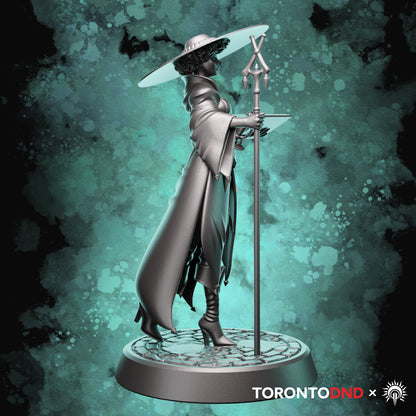 Left side view of a Human Wizard miniature highlighting flowing robes, staff length, and spellbook angle