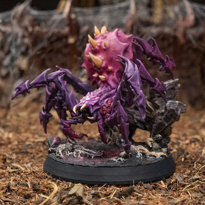 Close-up of Spider Colossus D&D miniature showing fangs, eyes, and spiked carapace