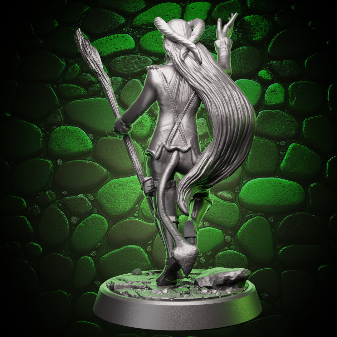 Back view of tiefling sorcerer mini figure showing long hair, tail, jacket seams, and staff held behind the body
